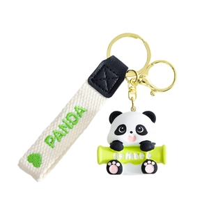 Cute resin panda keychain with bamboo charm and white embroidered woven wrist strap
