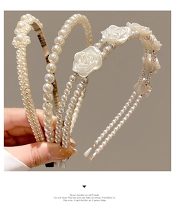 Detailed view of white pearl headbands for girls featuring resin roses and pearls