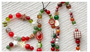 Detailed view of handmade beaded phone strap with colorful pearls and festive snowflake charms