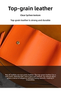 Detail of orange grain leather wallet with lychee pattern and metal snap button