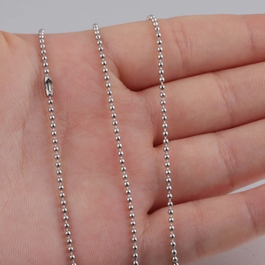 Detailed macro shot of 1.5mm stainless steel bead chain with connector on finger