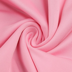 Macro shot of pink knit fabric texture showing soft ripples and premium material quality