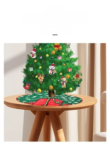 Detail showing dark green Christmas tree skirt with festive red gift box prints
