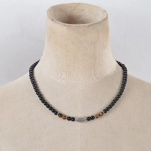 Detail of 6mm tiger eye and obsidian beaded necklace with silver OT clasp on mannequin