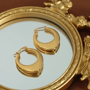 Golden chunky U-shaped hollow hoop earrings in a glossy stainless steel finish