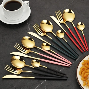 Portuguese stainless steel cutlery set with colorful handles on dark marble background