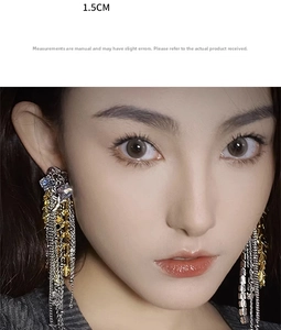 Detail of gold tassel earrings featuring sparkling zircon crystals and tiered long chains