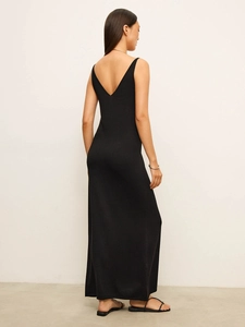Close-up of a black knitted dress showing low back design and fine fabric texture