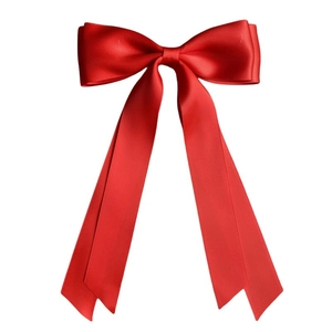 Detailed close-up of large red satin double-layered bow hair clip with smooth silk texture