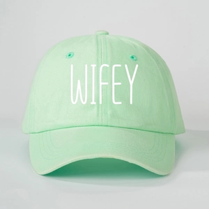 Detail of mint green cotton baseball cap with white WIFEY printed text embroidery
