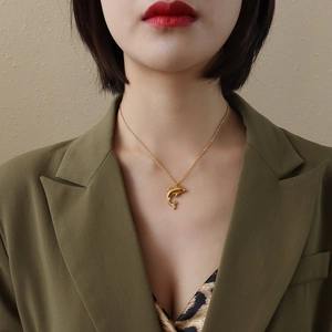 Golden dolphin pendant necklace on minimalist chain, elegant fashion jewelry for women