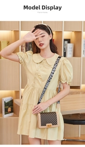 Detailed view of khaki contrast handbag with vintage patterns and branded wide strap