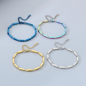Detailed shot of steel bracelets in blue, gold, silver, and rainbow geometric links