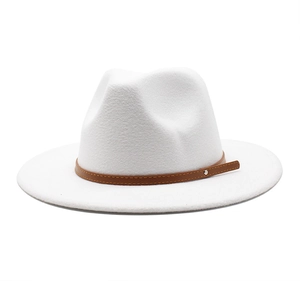 Close-up of white wool fedora hat featuring a brown leather band and silver rivet detail