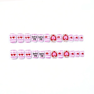 Short square pink glossy press-on nails with red hearts and BE MINE text designs