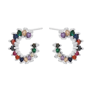 Macro detail of silver C-hoop earrings featuring multi-color micro-set zircon stones