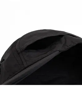 Detail view of ventilated mesh eyelets on a black quick-dry textured baseball cap