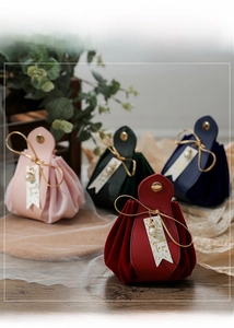 Macro detail of leather velvet wedding favor bags with drawstring and pearl tags