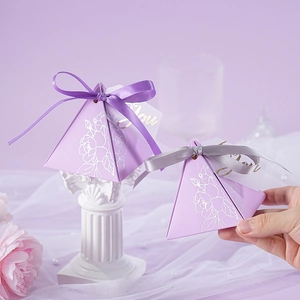 Elegant purple triangle candy box with white rose pattern and decorative ribbons