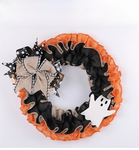 Detail of Halloween ghost wreath with orange and black burlap mesh and decorative bows