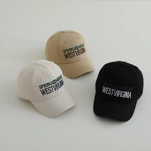 Three kids vintage baseball caps with WEST embroidery in beige, off-white, and black