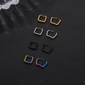 Macro shot of square titanium steel hoop earrings in gold silver black and rainbow colors