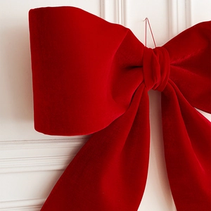 Oversized red velvet Christmas bow hanging ornament with soft velvet texture for tree decor