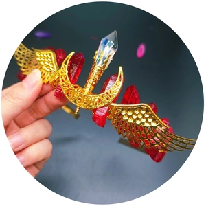 Handmade gold tiara with red crystals, moon and wing charms for bridal styling