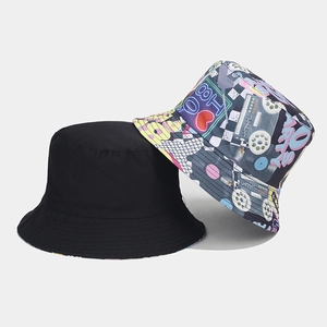 Detail of a reversible bucket hat showing classic black fabric and colorful retro tape patterns