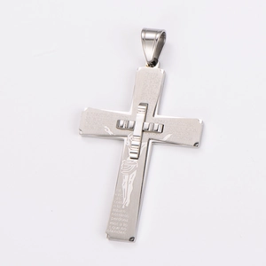 Macro view of silver cross pendant with crucifix detail and engraved religious text