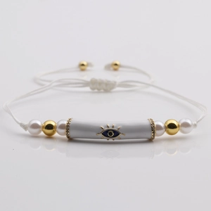Handmade Evil Eye beaded bracelet with copper beads and pearls on white cord