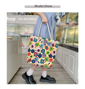 Close-up of a floral canvas tote bag featuring vibrant patterns and soft cotton rope handles
