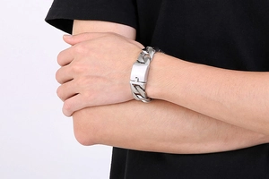 Close-up of 20mm silver Cuban link bracelet with square clasp on male wrist