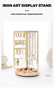 Close-up of golden iron art display stand with wooden tray and integrated hooks