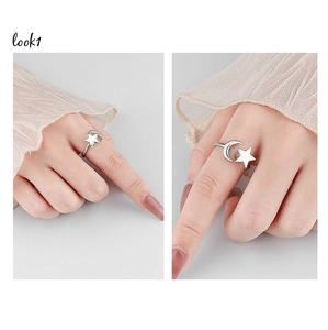Detailed close-up of adjustable silver star and moon ring with polished metallic finish