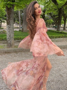 Detail of floral chiffon maxi dress with wide bell sleeves and high side slit