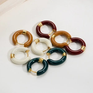 Macro view of French retro enamel hoop earrings in burgundy, camel, white and dark green