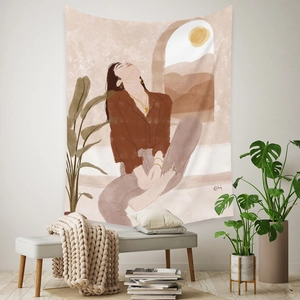 Detail of bohemian tapestry featuring an artistic desert female illustration in earth tones