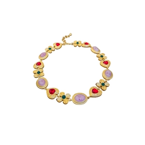 Vintage style gold necklace with red heart gemstone and floral cameo portrait design