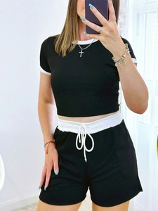 Close-up of black ribbed set featuring contrast white trim and drawstring waistband