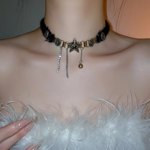 Close-up of black velvet star choker with dangling diamond and pearl tassels