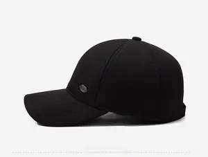 Close-up of side view of black wool baseball cap with metallic shield logo detail