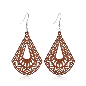 Detail shot of vintage geometric hollow wooden teardrop earrings on a white background