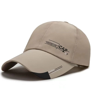 Detail of light khaki sports baseball cap showing printed letters and high-quality stitching