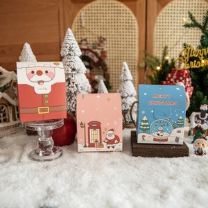 Creative Christmas apple gift boxes featuring snowman and reindeer designs on fake snow