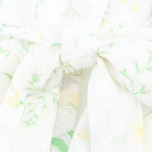 Elegant white floral V-neck maxi dress with green leaf print and waist tie detail