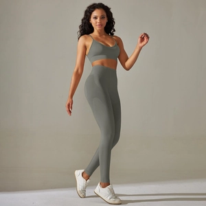 Close-up of seamless honeycomb texture on high-waist grey-green yoga leggings and sports bra