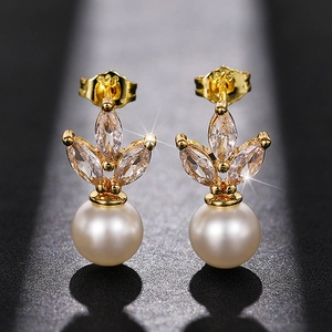 Macro shot of S925 sterling silver butterfly backings on pearl earrings with shiny zircons