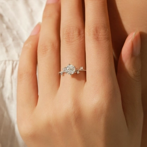 Elegant six-prong 1-carat moissanite ring with small side diamonds on silver band