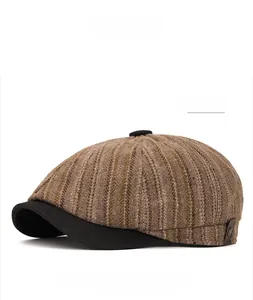 Detail view of khaki striped newsboy cap with textured fabric and vintage side metal button